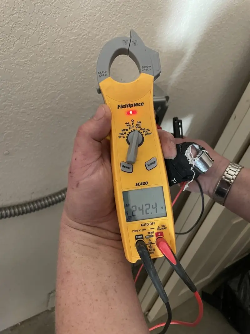 Voltage testing with clamp meter during Electrical Installation Services in Ellery